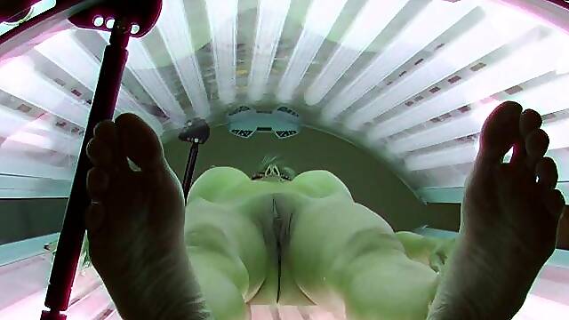 Busty model in solarium